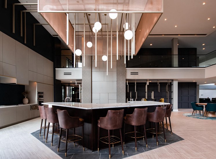large indoor bar with 7 barstools seated around the countertop